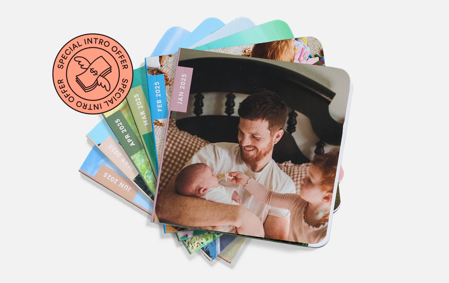 Stack of custom photo calendars with a "Special Intro Offer" seal. The top calendar shows a smiling man holding a baby, with a child nearby. Warm, joyful tone.