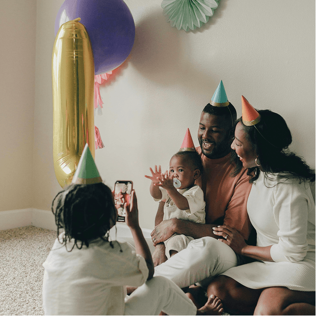 Family celebrating a birthday with their toddler