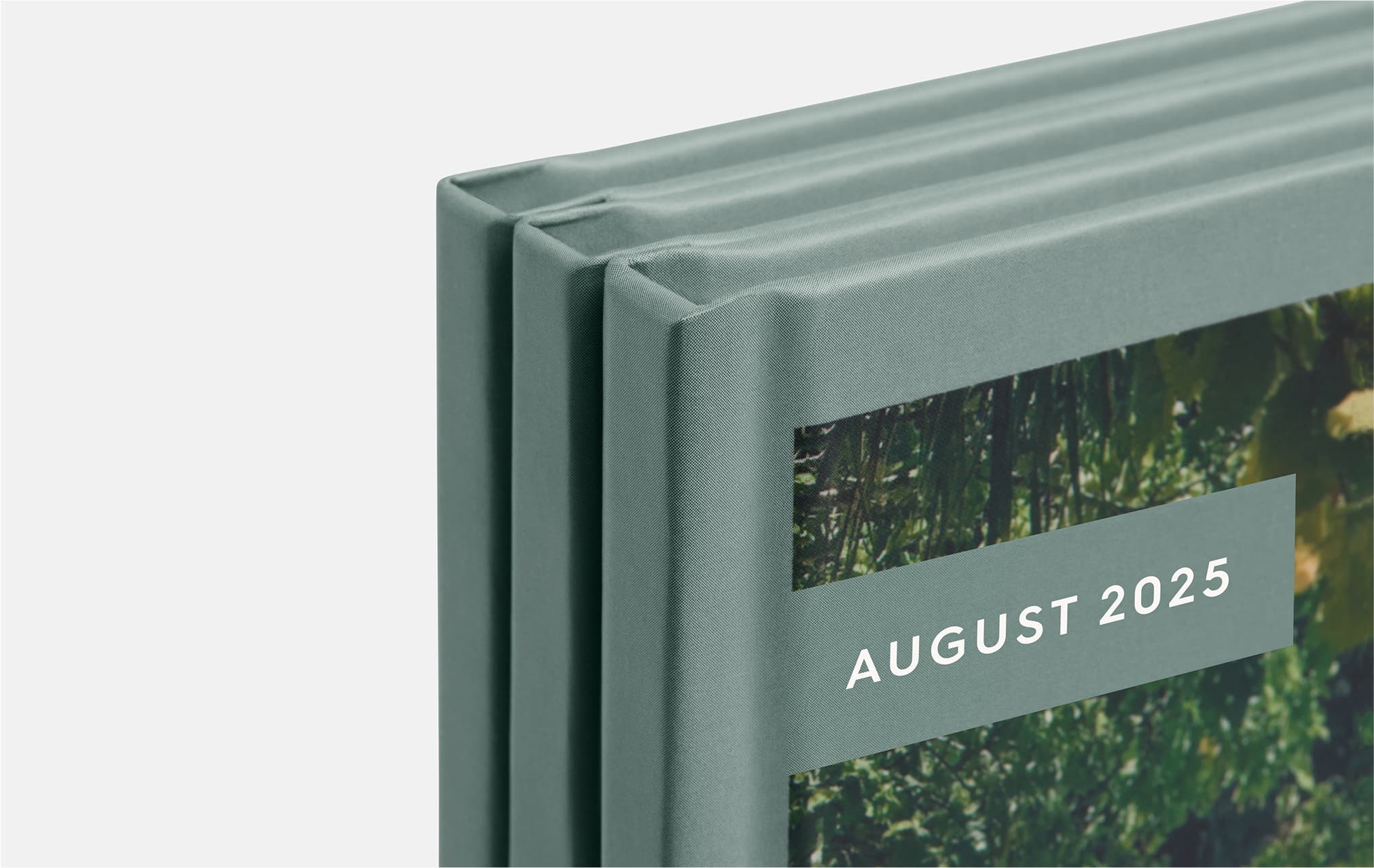 Four photo books displayed, each featuring unique colors and designs, showcasing a variety of styles and themes.