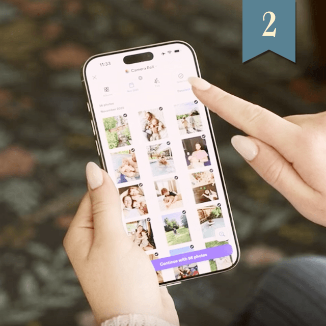 Hands holding a phone reviewing photos in the Chatbooks app