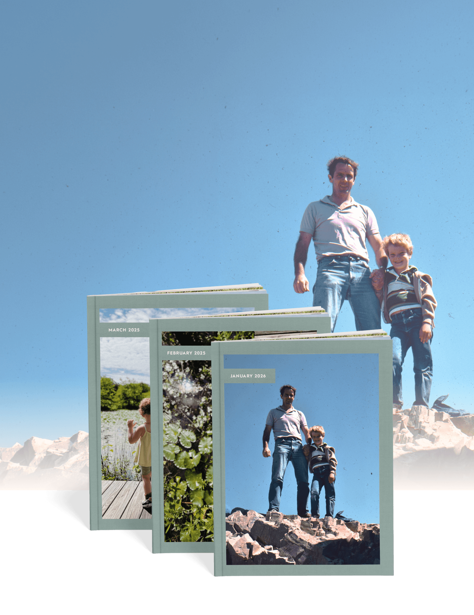 Dad and son standing on rocks alongside three Monthbooks of family photos